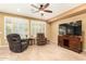 Inviting living room with plush seating, plantation shutters, and a ceiling fan at 20515 N 271St Ave, Buckeye, AZ 85396