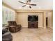 Cozy living room showcasing a TV, ceiling fan, and plantation shutters at 20515 N 271St Ave, Buckeye, AZ 85396