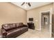 A light filled office area with a brown leather sofa and views to the bathroom at 20515 N 271St Ave, Buckeye, AZ 85396