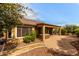 Charming covered patio with a hot tub and beautiful landscaping around the home's exterior at 20515 N 271St Ave, Buckeye, AZ 85396