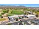 Aerial view of a clubhouse and golf course surrounded by lush greenery and upscale homes at 22419 W La Pasada Blvd, Buckeye, AZ 85326