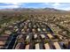 Aerial view of a community with a mix of housing styles, golf course, and mountain views at 22419 W La Pasada Blvd, Buckeye, AZ 85326