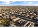 A dense neighborhood showcasing numerous homes, some equipped with solar panels, under a clear blue sky at 22419 W La Pasada Blvd, Buckeye, AZ 85326