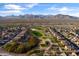 Expansive aerial view of homes near a golf course with mountain views in the distance at 22419 W La Pasada Blvd, Buckeye, AZ 85326