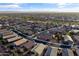 Aerial view of a well-maintained neighborhood featuring neatly arranged homes and landscaping at 22419 W La Pasada Blvd, Buckeye, AZ 85326