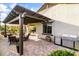 Backyard with covered patio, BBQ, brick pavers and lush, green landscaping at 22419 W La Pasada Blvd, Buckeye, AZ 85326