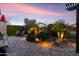 Outdoor kitchen and grill on the patio with chairs and manicured lawn at 22419 W La Pasada Blvd, Buckeye, AZ 85326