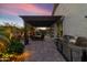 Backyard patio with a covered dining table and a stainless steel grill at 22419 W La Pasada Blvd, Buckeye, AZ 85326