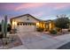 Charming single-story home featuring a well-manicured front yard and a two-car garage at 22419 W La Pasada Blvd, Buckeye, AZ 85326