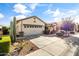 Charming single-story home with a two-car garage, desert landscaping, and a well-maintained front yard at 22419 W La Pasada Blvd, Buckeye, AZ 85326