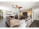 Spacious living room featuring a stone accent wall and an open floor plan leading to the kitchen and dining area at 22419 W La Pasada Blvd, Buckeye, AZ 85326