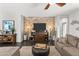 Cozy living room featuring hardwood floors, stylish brick accent wall, recessed lighting, and ample seating at 22419 W La Pasada Blvd, Buckeye, AZ 85326