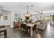 Open-concept living area with a combination dining room and living room with dark wood floors and neutral paint at 22419 W La Pasada Blvd, Buckeye, AZ 85326