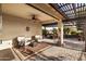 Covered patio featuring stone flooring, ceiling fan, and outdoor furniture at 22419 W La Pasada Blvd, Buckeye, AZ 85326
