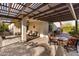 Covered patio space with brick flooring, ceiling fan, and outdoor dining and seating at 22419 W La Pasada Blvd, Buckeye, AZ 85326