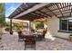 Covered outdoor patio featuring stone flooring, wood pergola, and outdoor seating at 22419 W La Pasada Blvd, Buckeye, AZ 85326