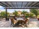 Rear patio featuring a pergola, brick pavers, outdoor seating, and mature trees at 22419 W La Pasada Blvd, Buckeye, AZ 85326