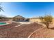 Expansive backyard featuring desert landscaping, stepping stones, and a covered patio area ideal for outdoor living at 22727 W Papago St, Buckeye, AZ 85326