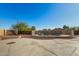 Backyard featuring a fenced pool area with desert landscaping, stepping stones, and a spacious concrete pad at 22727 W Papago St, Buckeye, AZ 85326