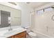 Bathroom featuring a vanity, toilet, and shower-tub combination with a window at 22727 W Papago St, Buckeye, AZ 85326