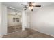 A bright bedroom with mirrored closet doors and a ceiling fan provides ample space and storage at 22727 W Papago St, Buckeye, AZ 85326