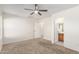 Spacious carpeted bedroom with an adjacent bathroom featuring a vanity at 22727 W Papago St, Buckeye, AZ 85326