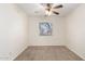 A cozy bedroom with neutral walls, carpet, and a ceiling fan fixture offers a calm and inviting space at 22727 W Papago St, Buckeye, AZ 85326