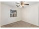 Bedroom with a window and ceiling fan that offers natural light and a comfortable atmosphere at 22727 W Papago St, Buckeye, AZ 85326