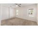 Carpeted bedroom with a ceiling fan and a sliding closet door at 22727 W Papago St, Buckeye, AZ 85326
