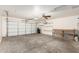 Spacious two car garage with shelves, a work bench and clean concrete floors at 22727 W Papago St, Buckeye, AZ 85326