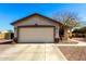 A single-Gathering home featuring a two-car garage and manicured landscaping at 22727 W Papago St, Buckeye, AZ 85326