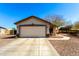 A single-Gathering home featuring a two-car garage and manicured landscaping at 22727 W Papago St, Buckeye, AZ 85326