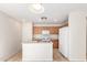 Bright kitchen with wood cabinets, white appliances, and an island with a sink at 22727 W Papago St, Buckeye, AZ 85326