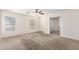 Spacious living room featuring neutral carpeting and two bright windows at 22727 W Papago St, Buckeye, AZ 85326