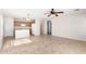Open-concept living room and kitchen with tile flooring and a ceiling fan at 22727 W Papago St, Buckeye, AZ 85326