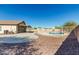 Backyard features a refreshing pool, concrete patio and desert landscaping at 22727 W Papago St, Buckeye, AZ 85326