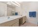 Bright bathroom showcasing double sinks, a full mirror, and a shower-tub combo at 24832 S Boxwood Dr, Sun Lakes, AZ 85248