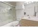 A clean bathroom featuring a shower-tub combo with glass doors, a toilet, and a sink at 24832 S Boxwood Dr, Sun Lakes, AZ 85248