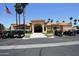 Well-maintained building exterior with a classic design and convenient parking for golf carts at 24832 S Boxwood Dr, Sun Lakes, AZ 85248