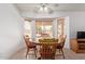 Inviting dining area with a circular wood table, comfortable seating, and bright natural light at 24832 S Boxwood Dr, Sun Lakes, AZ 85248