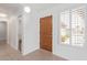 Bright foyer featuring tile floors, wood door and window with shutter, and ample natural light at 24832 S Boxwood Dr, Sun Lakes, AZ 85248