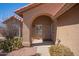 Inviting home entrance with an arched doorway and desert landscaping for curb appeal at 24832 S Boxwood Dr, Sun Lakes, AZ 85248