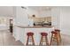 The kitchen features a convenient breakfast bar with seating and seamless access to the living room at 24832 S Boxwood Dr, Sun Lakes, AZ 85248