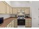 Functional kitchen featuring cream cabinets, countertops, and appliances, with ample cabinet space at 24832 S Boxwood Dr, Sun Lakes, AZ 85248