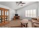 Cozy living room with a vaulted ceiling, wood floors, and plantation shutters on the windows at 24832 S Boxwood Dr, Sun Lakes, AZ 85248