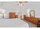 Bright main bedroom with neutral walls, carpet, ceiling fan and wooden furniture at 24832 S Boxwood Dr, Sun Lakes, AZ 85248