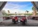 Charming outdoor seating area overlooking a serene lake, perfect for relaxing and dining at 24832 S Boxwood Dr, Sun Lakes, AZ 85248