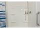 Shower with built-in shelves, safety bars, and a blue and white striped shower curtain at 24832 S Boxwood Dr, Sun Lakes, AZ 85248