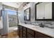 Modern bathroom with a double sink vanity, decorative mirrors, and a shower-tub combo at 2517 W Balao Dr, Phoenix, AZ 85085