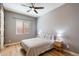 Bright bedroom with wood floors, a ceiling fan, and a large window for ample natural light at 2517 W Balao Dr, Phoenix, AZ 85085